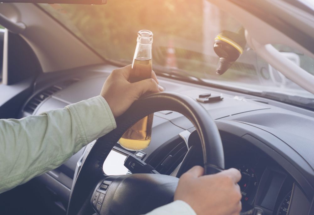 Drunk and Impaired Driving Incidences Driver with beer bottle in hand