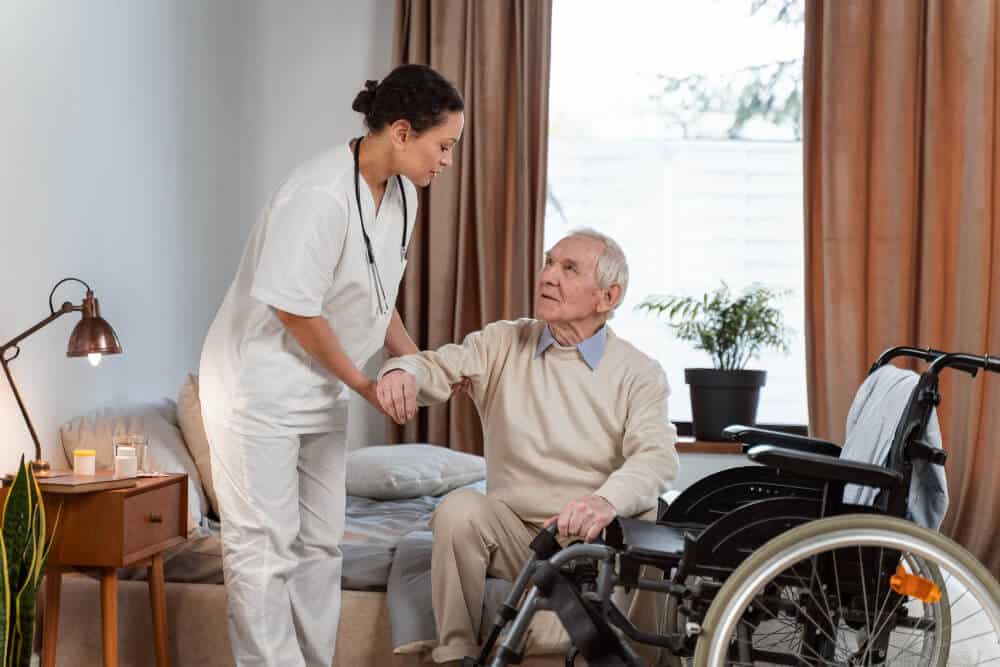 Nurse on Elder Care Nurse Helping Elder Patient to His Wheelchair