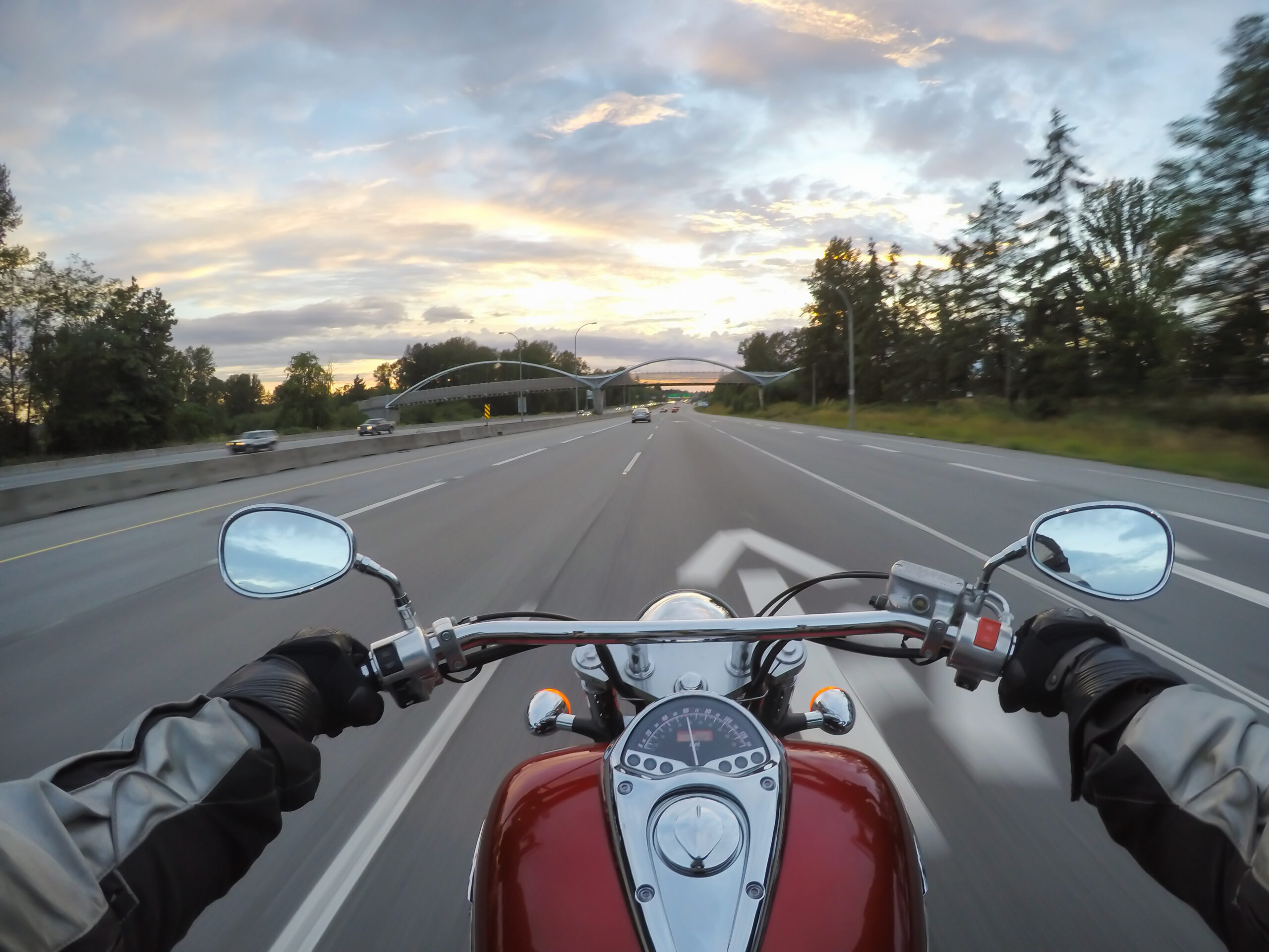 Riding a motorcycle during a vibrant sunset. Taken in Surrey, Greater Vancouver, British Columbia, Canada.