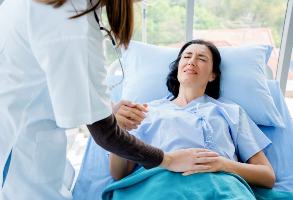 Patient in Distress Woman in hospital bed with doctor