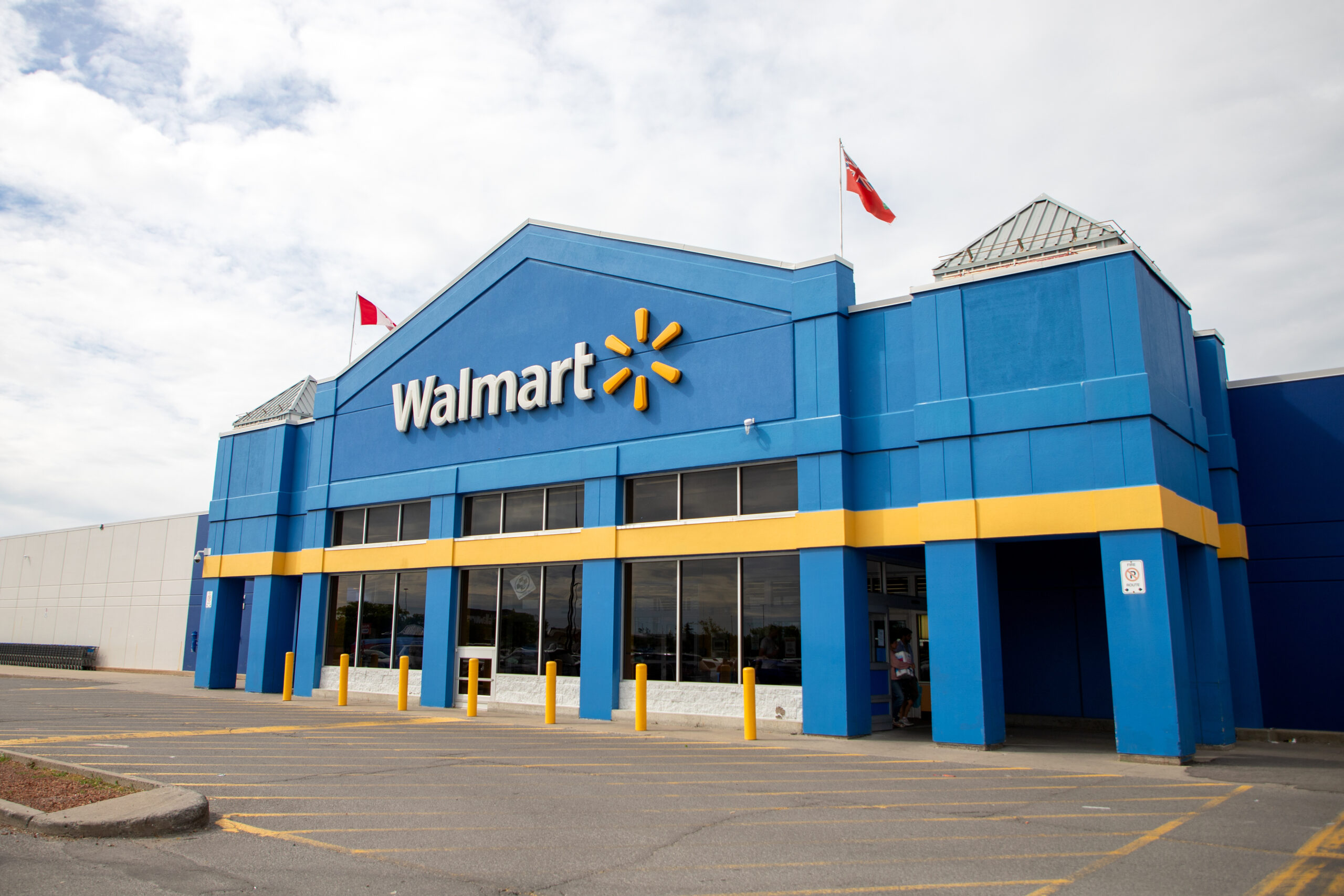 Kanata, Canada - June 2, 2024: Walmart retail store building with Canadian and Ontario flags