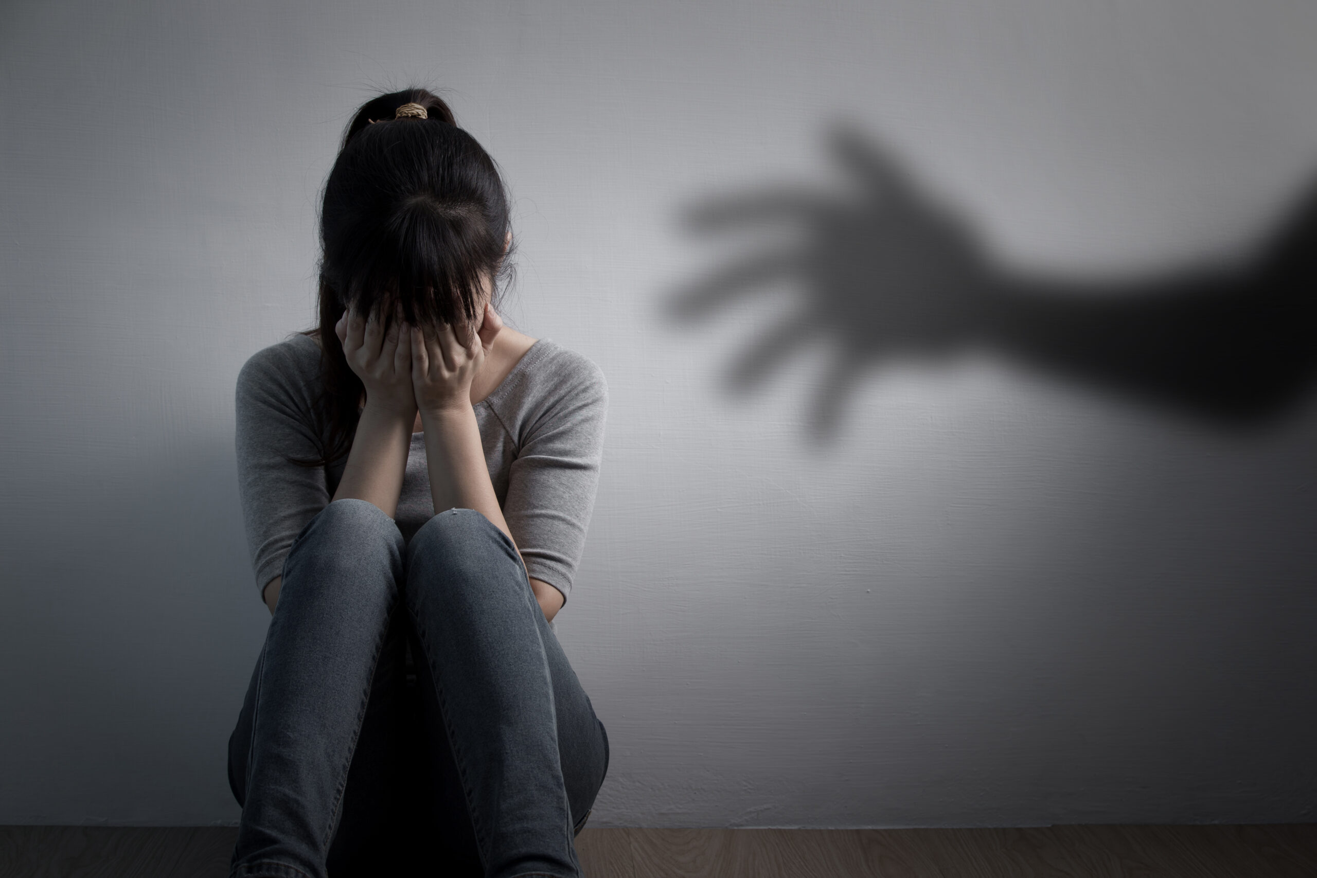 The depression woman sit on the floor with sexual harassment concept