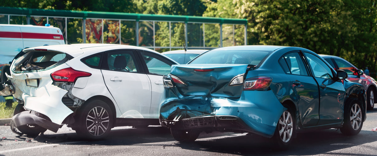 Traffic collision scene with damaged cars